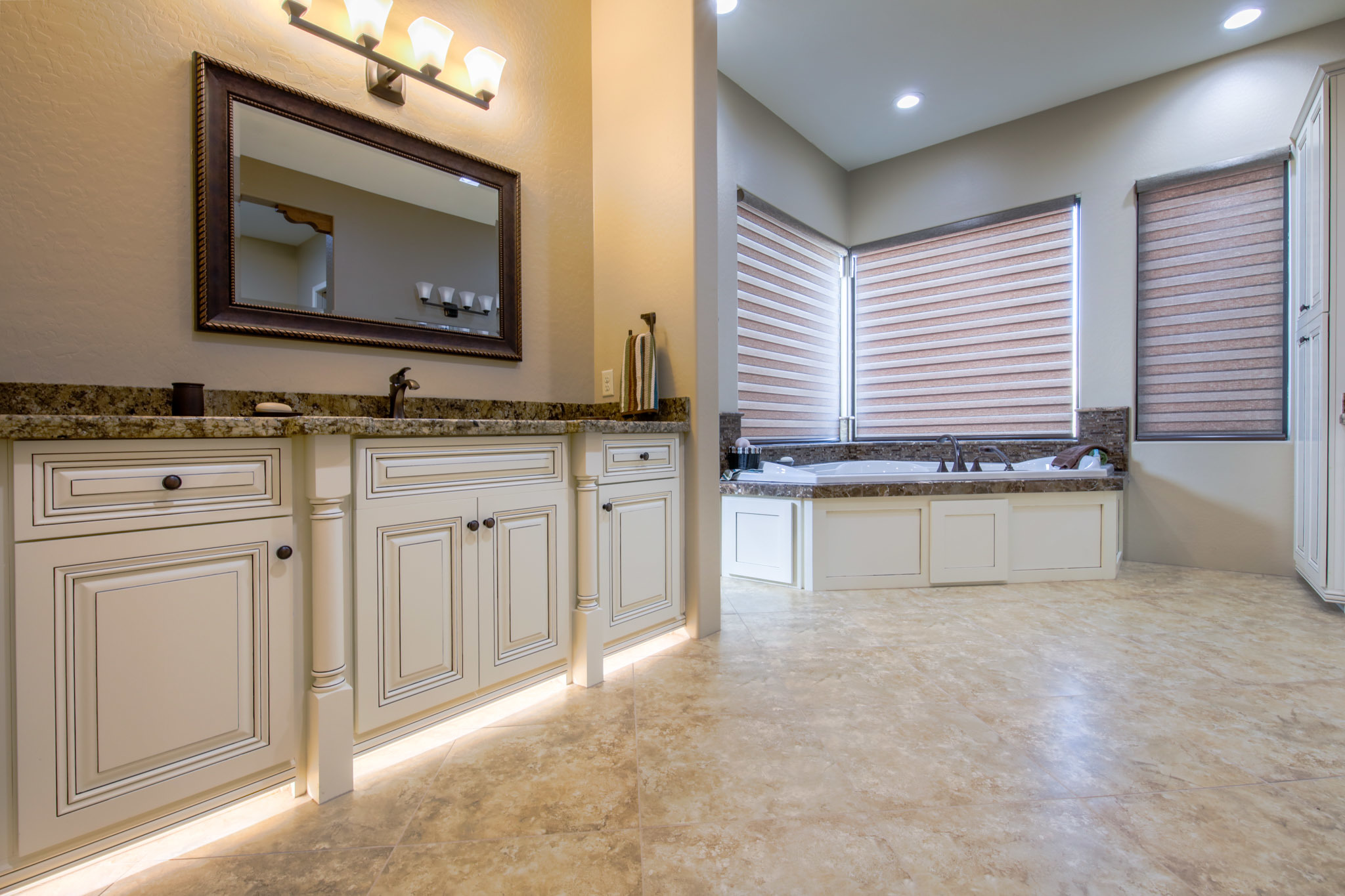 Master bathroom remodel by Maverick Kitchens featuring custom vanity, granite countertops, and soaking tub